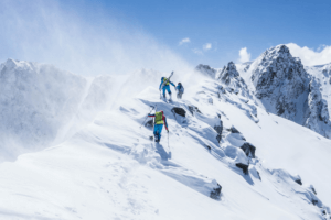 back country skiers hiking mountain ridge