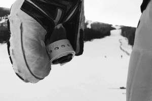 Preview image of a rolled Skiezy Performance ski strap being applied for ski security